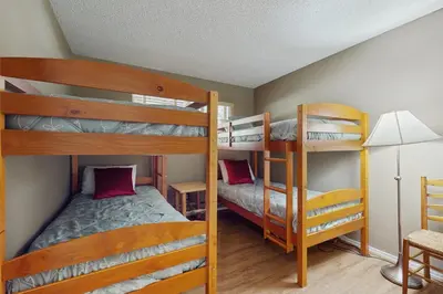 a bedroom with two bunk beds and a desk at Sierra Snow Haven in Incline Village