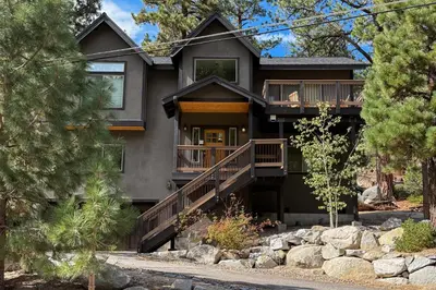 a large house with a deck and trees at Tahoe Boulders in South Lake Tahoe