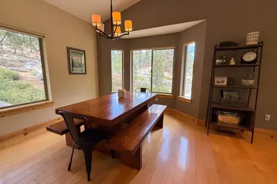 a dining room with a wooden table with a bench at Tahoe Boulders in South Lake Tahoe