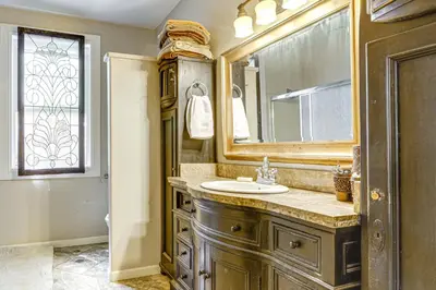 a bathroom with a sink and a mirror at All-Season Outdoor Base Camp Gold Country Home! in Fiddletown