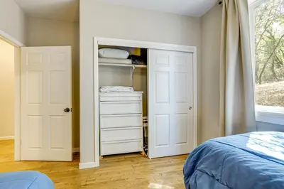 a bedroom with a closet with two white doors at All-Season Outdoor Base Camp Gold Country Home! in Fiddletown