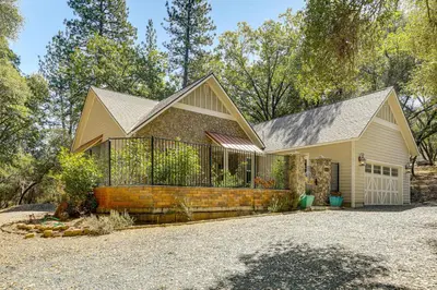 a house with a fence and a driveway at All-Season Outdoor Base Camp Gold Country Home! in Fiddletown
