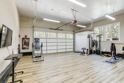 a gym with treadmills and machines in a room at All-Season Outdoor Base Camp Gold Country Home! in Fiddletown