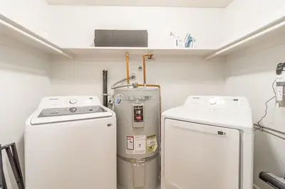 a laundry room with two washer and dryers in it at Designer Living Pet-Friendly UNR 2BR 1BA in Reno