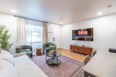 a living room with a couch and a tv at Designer Living Pet-Friendly UNR 2BR 1BA in Reno