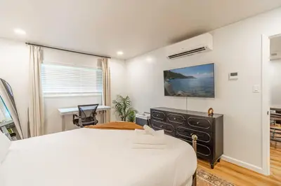 a bedroom with a large white bed and a window at Designer Living Pet-Friendly UNR 2BR 1BA in Reno