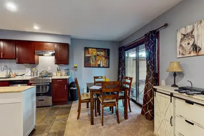 a kitchen and dining room with a table and chairs at Fireside 106 in Mammoth Lakes