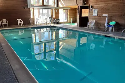 a swimming pool with chairs in a building at Fireside 106 in Mammoth Lakes