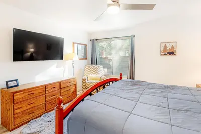 a bedroom with a large bed and a tv at Sunshine Village 169 in Mammoth Lakes