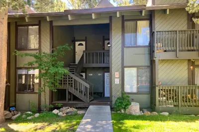 a house with a staircase and a porch at Sunshine Village 169 in Mammoth Lakes