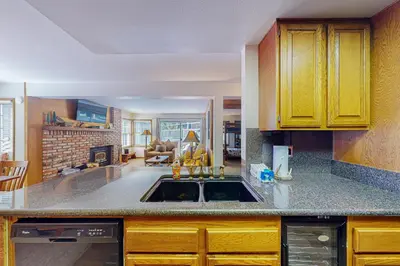 a kitchen with yellow cabinets and a sink at Sierra Megeve 3 in Mammoth Lakes
