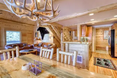 a dining room and living room with a chandelier at Sierra Megeve 29 in Mammoth Lakes