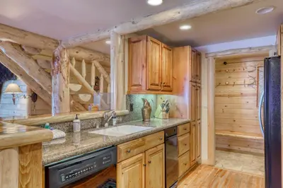 a kitchen with wooden cabinets and a sink at Sierra Megeve 29 in Mammoth Lakes