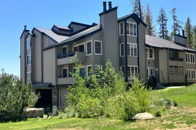 a large house on top of a grassy field at Sierra Megeve 29 in Mammoth Lakes