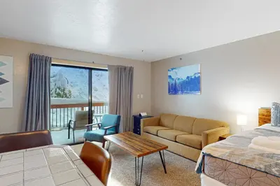 a hotel room with a bed and a couch and a table at Yosemite West Condo B104 in Yosemite West