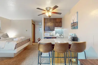 a bedroom with a bed and a table with chairs at Yosemite West Condo B104 in Yosemite West