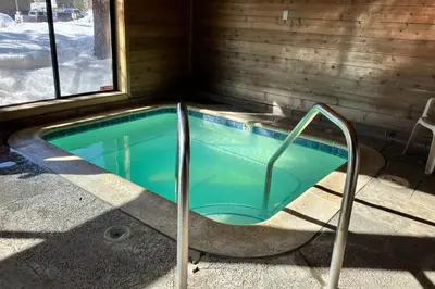 a jacuzzi tub in a cabin with a window at Fireside 111 in Mammoth Lakes
