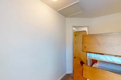 a bedroom with a wooden bed in a room at Moler Lake House in Bass Lake