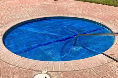 a blue swimming pool with a pole in it at Moler Lake House in Bass Lake