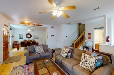 a living room with two couches and a ceiling fan at Moler Lake House in Bass Lake