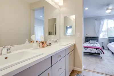 a bathroom with two sinks and a large mirror at Home Base with Easy 1-80 Access 4 Mi to Dtwn Reno! in Reno