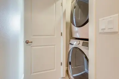 a washing machine with a microwave on top of it at Home Base with Easy 1-80 Access 4 Mi to Dtwn Reno! in Reno