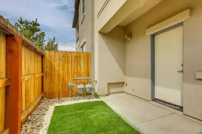 a backyard with a wooden fence and grass at Home Base with Easy 1-80 Access 4 Mi to Dtwn Reno! in Reno