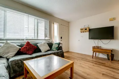 a living room with a couch and a flat screen tv at 2 Mi to Dtwn Reno and UNR City-View Townhome! in Reno