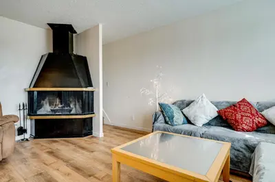 a living room with a couch and a fireplace at 2 Mi to Dtwn Reno and UNR City-View Townhome! in Reno