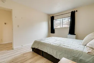 a bedroom with a bed and a window at 2 Mi to Dtwn Reno and UNR City-View Townhome! in Reno