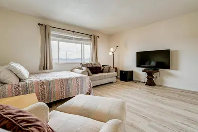 a living room with a couch and a flat screen tv at 2 Mi to Dtwn Reno and UNR City-View Townhome! in Reno