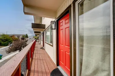 a red door on the side of a building at 2 Mi to Dtwn Reno and UNR City-View Townhome! in Reno