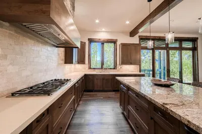 a kitchen with wooden cabinets and a stove top oven at Rising Sun Retreat at Schaffer's Mill by Tahoe Getaways - Luxury Pet Friendly w Air Conditioning in Truckee