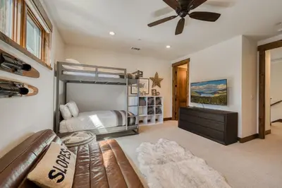 a bedroom with a bunk bed and a couch at Rising Sun Retreat at Schaffer's Mill by Tahoe Getaways - Luxury Pet Friendly w Air Conditioning in Truckee