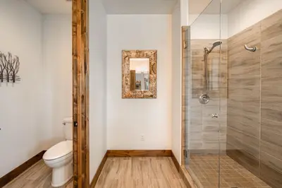 a bathroom with a toilet and a glass shower at Rising Sun Retreat at Schaffer's Mill by Tahoe Getaways - Luxury Pet Friendly w Air Conditioning in Truckee
