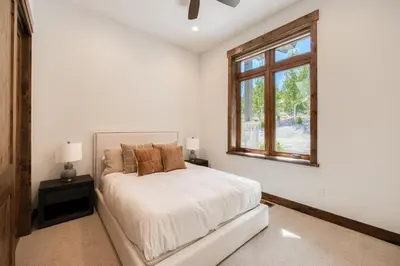 a white bedroom with a bed and a window at Rising Sun Retreat at Schaffer's Mill by Tahoe Getaways - Luxury Pet Friendly w Air Conditioning in Truckee