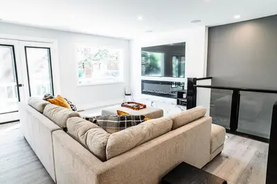 a living room with a large couch and a kitchen at Mammoth Lakes Ski Getaway in Mammoth Lakes