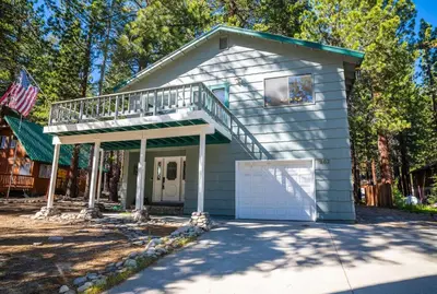 a small house with a porch and a balcony at Mammoth Lakes Ski Getaway in Mammoth Lakes