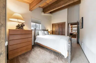 a bedroom with a bed and a lamp on a dresser at Townhouse wLake View #254 at Donner Lake Village in Truckee