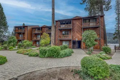 an exterior view of an apartment building with a courtyard at Townhouse wLake View #254 at Donner Lake Village in Truckee