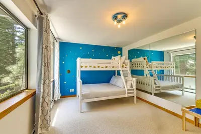 two bunk beds in a room with blue walls at 3 Mi to Lake Tahoe Forest-View Sanctuary with Deck! in Incline Village