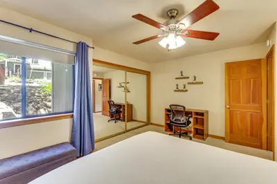 a bedroom with a ceiling fan and a window at 3 Mi to Lake Tahoe Forest-View Sanctuary with Deck! in Incline Village