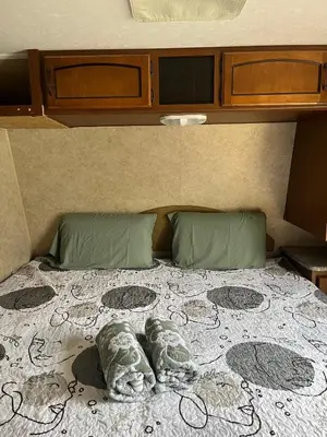 a bed with two pillows on top of it at Comfortable Guest RV With EV charger Semi Rural Area in Bodfish