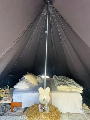 a bedroom with a bed in a tent at Rocky Ridge Glamping Yosemite in Coarsegold