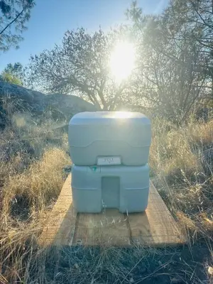 a cooler sitting on a wooden path in a field at Rocky Ridge Glamping Yosemite in Coarsegold