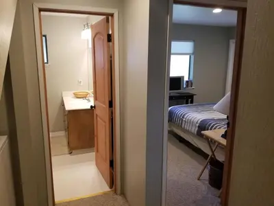 a room with a bedroom with a bed and a mirror at Kirkwood On Meadow 3br 1 ba in Kirkwood