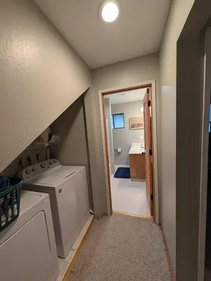 a laundry room with a sink and a washer at Kirkwood On Meadow 3br 1 ba in Kirkwood