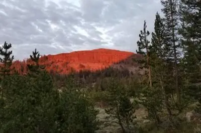 a red mountain in the middle of a forest at Kirkwood On Meadow 3br 1 ba in Kirkwood