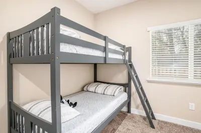 a gray bunk bed with a ladder in a room at The Oakhurst Oasis - Family & Fun Edition in Oakhurst
