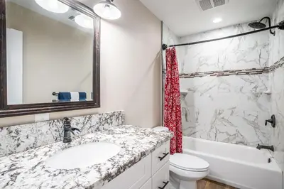 a bathroom with a sink and a toilet and a tub at The Oakhurst Oasis - Family & Fun Edition in Oakhurst